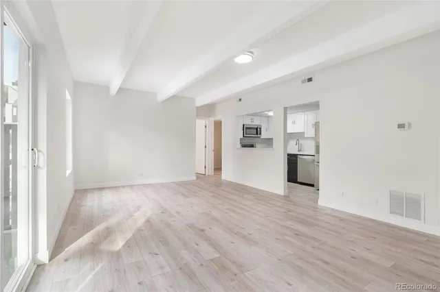 a view of a kitchen with a sink and a refrigerator