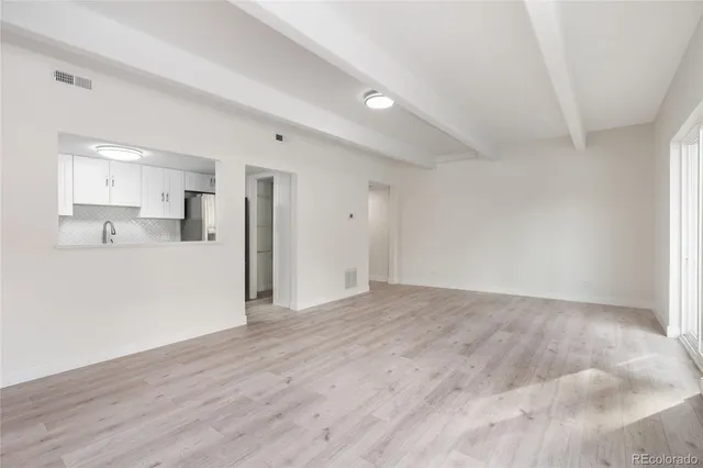 a view of kitchen and empty room