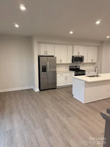 a white toilet sitting next to a white sink