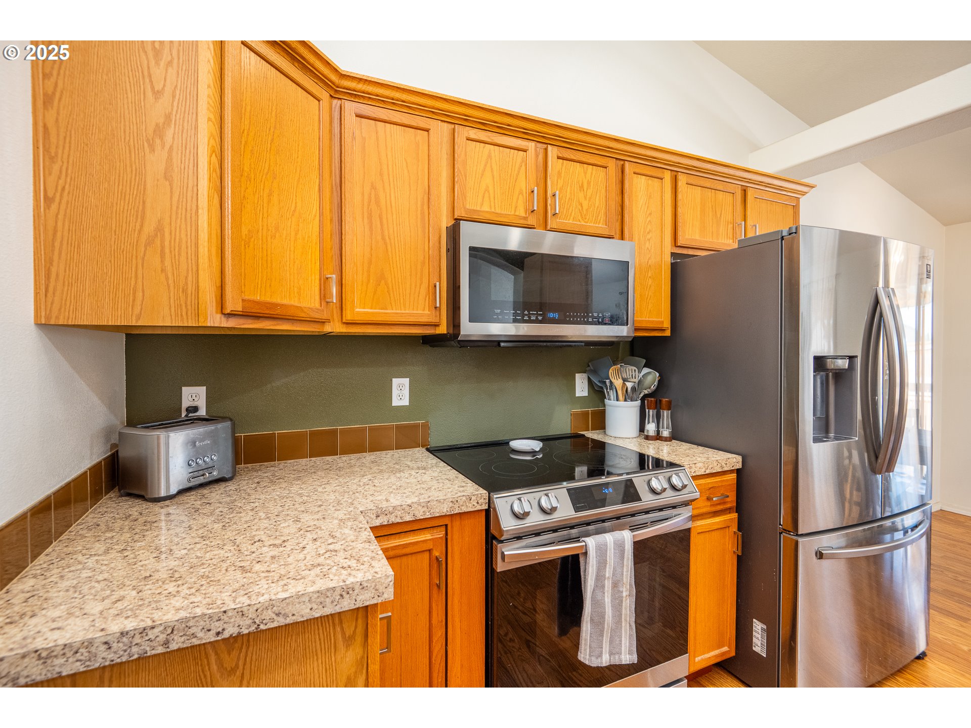 2002 South 60th Street Springfield, OR 97478 - Photo 12 of 47 a kitchen with stainless steel appliances granite countertop a stove a refrigerator and a microwave