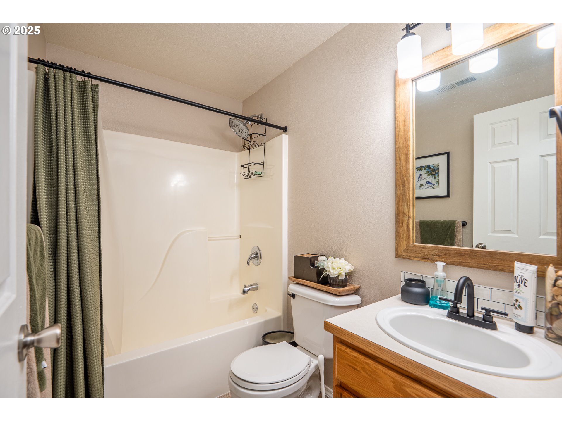 2002 South 60th Street Springfield, OR 97478 - Photo 27 of 47 a bathroom with a granite countertop sink toilet a mirror a vanity and shower