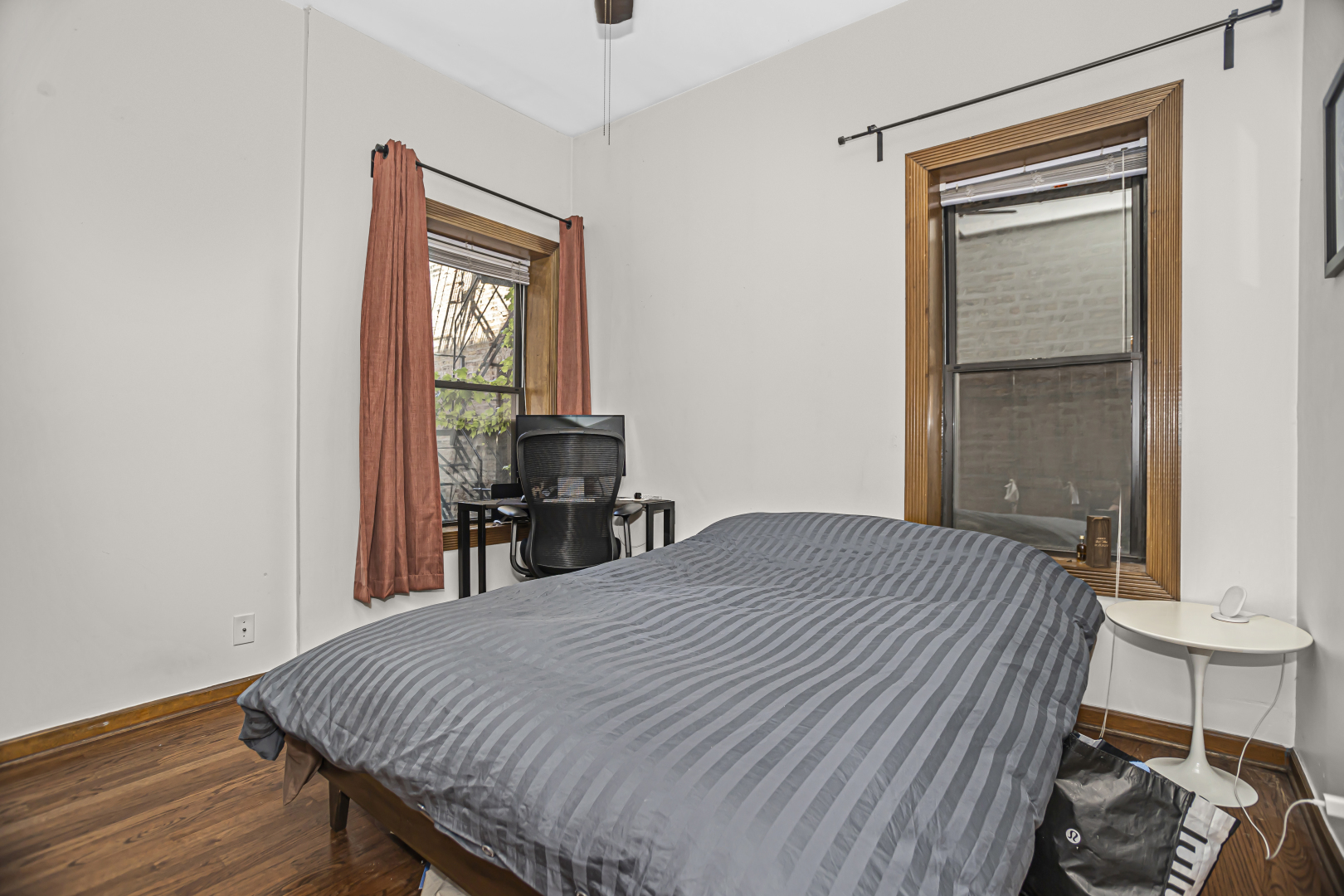 4030 North Sheridan Road, Unit 1R Chicago, IL 60613 - Photo 11 of 16 a bed sitting in a bedroom next to a window