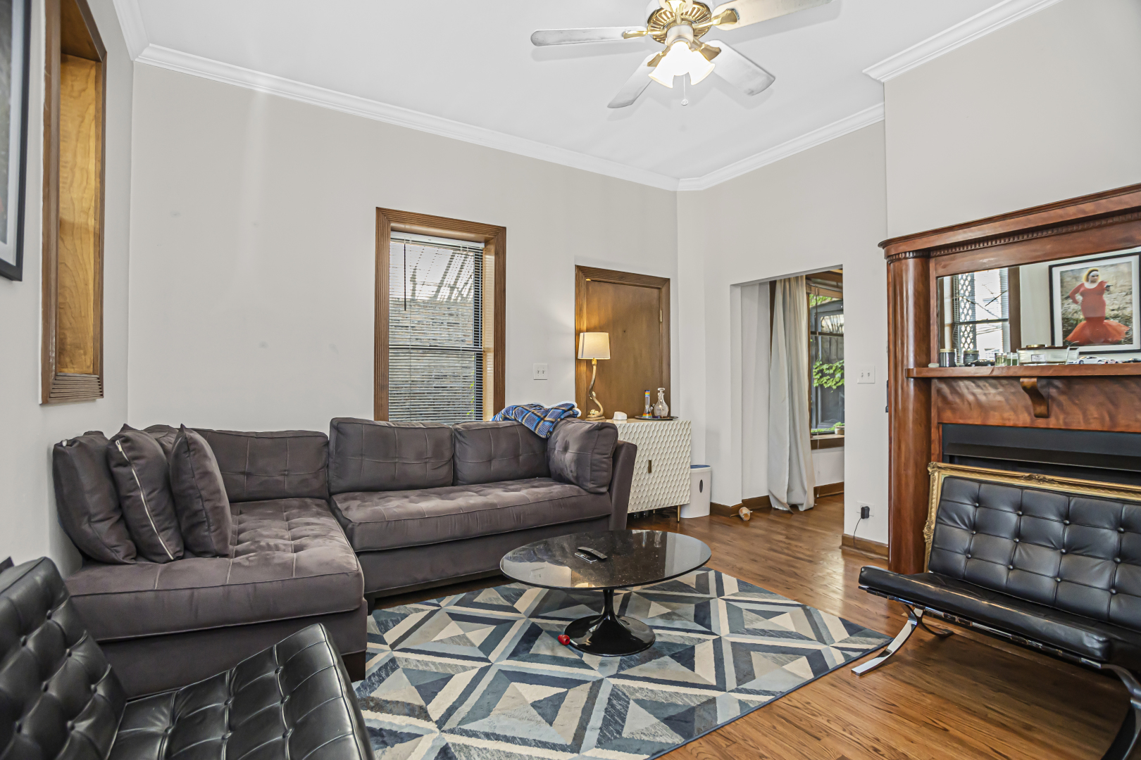 4030 North Sheridan Road, Unit 1R Chicago, IL 60613 - Photo 5 of 16 a living room with furniture a fireplace and a window