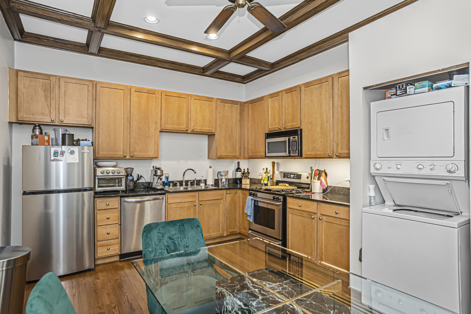 4030 North Sheridan Road, Unit 1R Chicago, IL 60613 - Photo 8 of 16 a kitchen with granite countertop stainless steel appliances a stove refrigerator sink and microwave