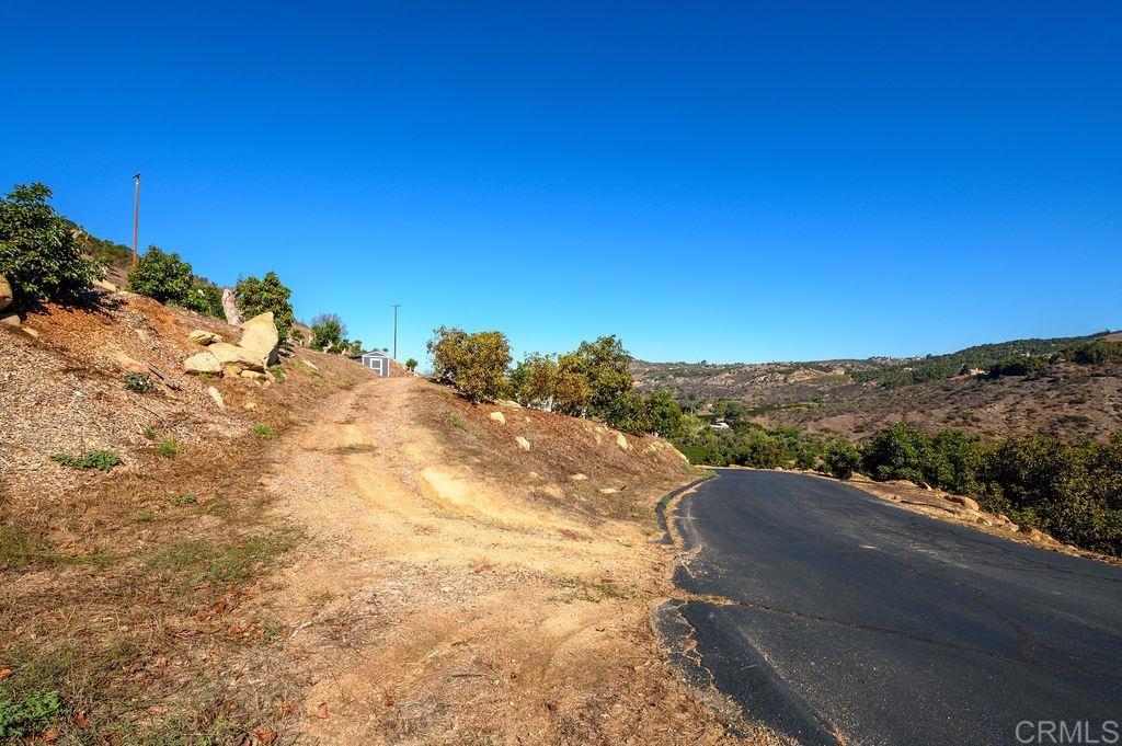 30580 Luis Rey Heights Road Bonsall, CA 92084 - Photo 7 of 8 a view of a dry yard with mountains in the background