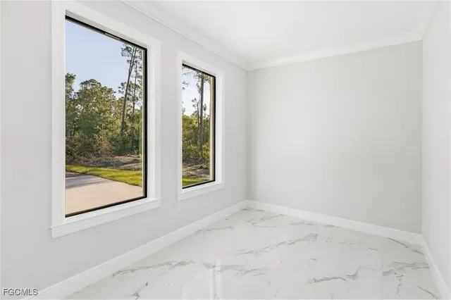 an empty room with fan and windows