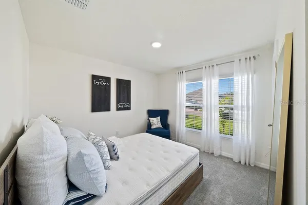 a bedroom with a large bed and a window