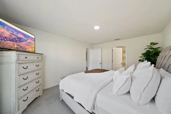 a bedroom with a bed and a dresser