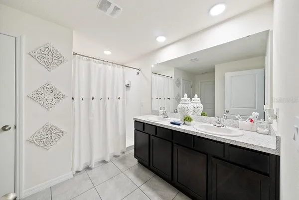 a bathroom with a double vanity sink and a mirror