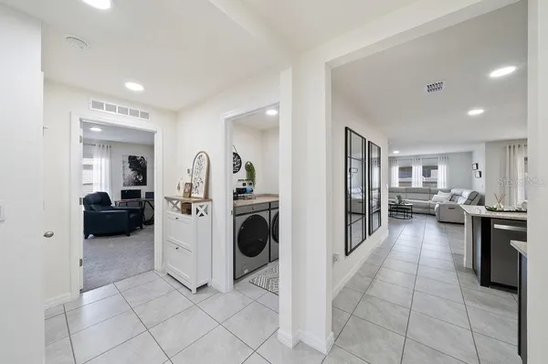 a living room with furniture and kitchen view