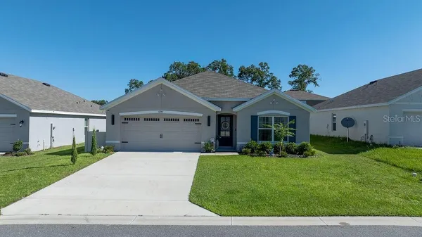 a front view of a house with a yard and garage