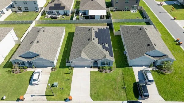 an aerial view of a house with a swimming pool