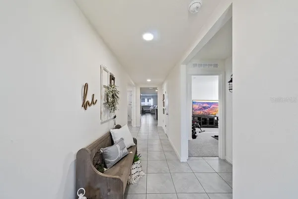 a hallway with a view of living room