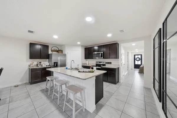a kitchen with a sink stainless steel appliances and cabinets