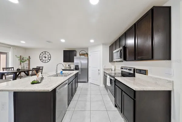 a kitchen with stainless steel appliances granite countertop a sink counter space and cabinets
