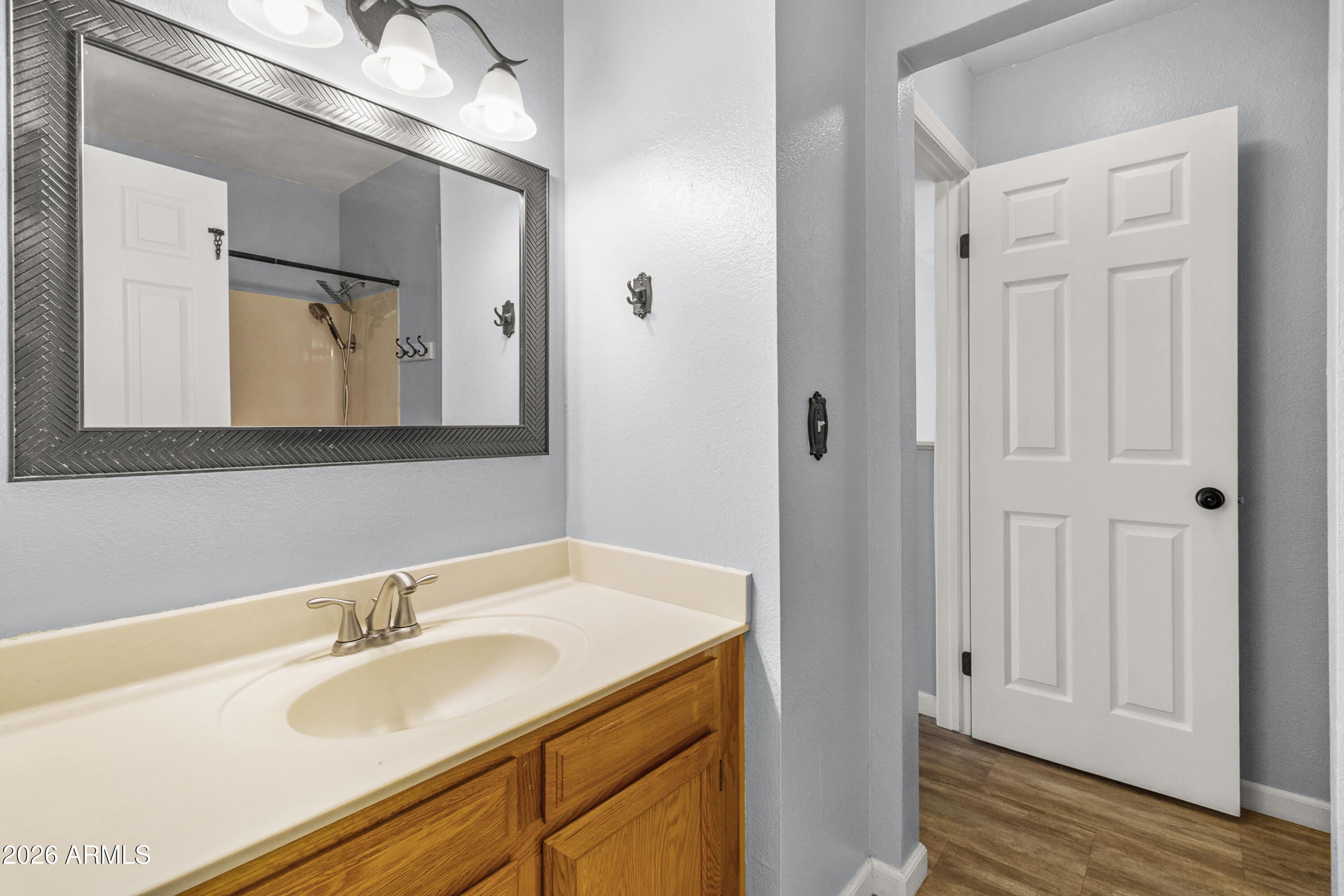 1645 West Baseline Road, Unit 2110 Mesa, AZ 85202 - Photo 11 of 17 a bathroom with a tub sink and mirror