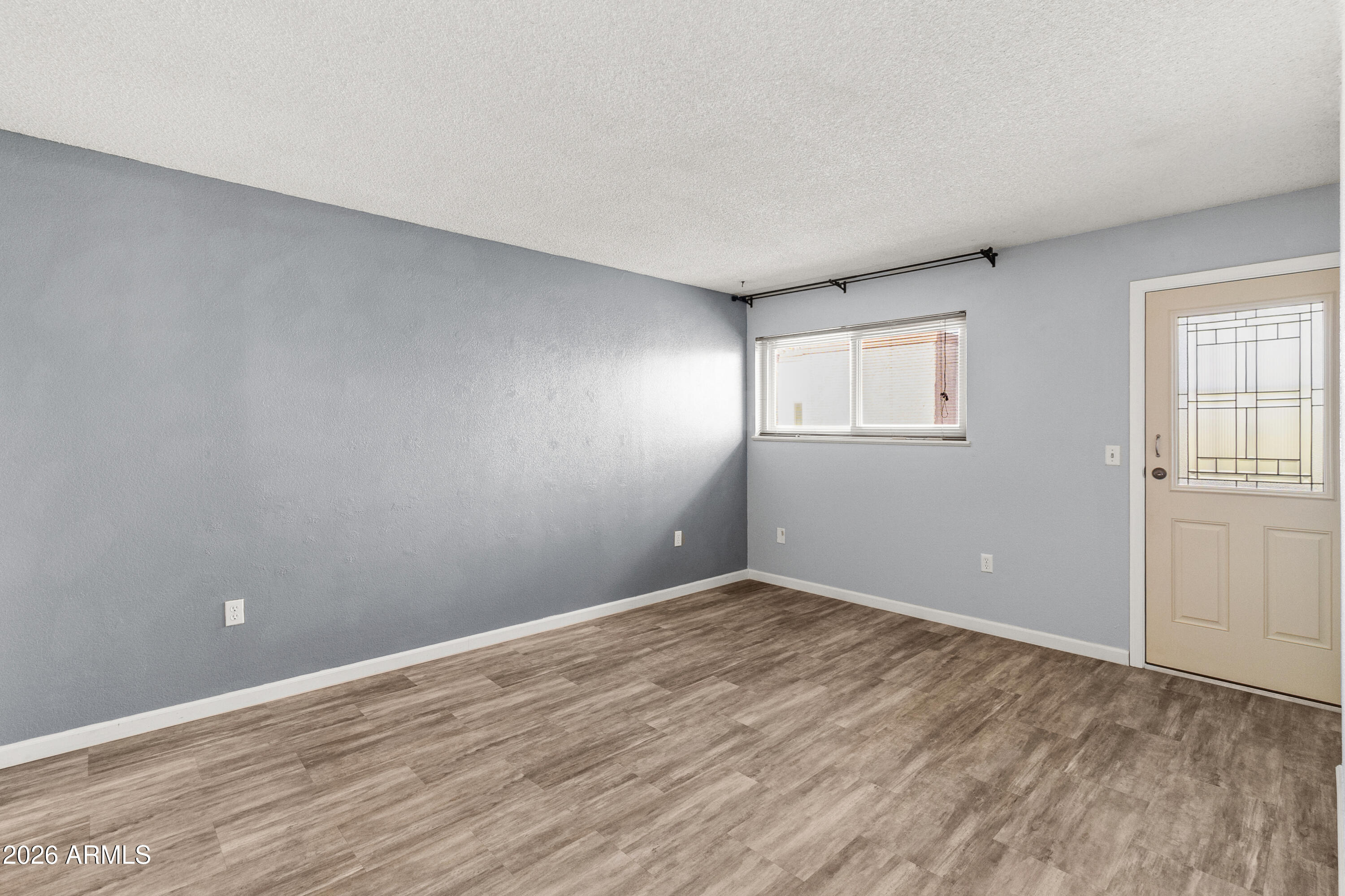 1645 West Baseline Road, Unit 2110 Mesa, AZ 85202 - Photo 12 of 17 wooden floor in an empty room with a window