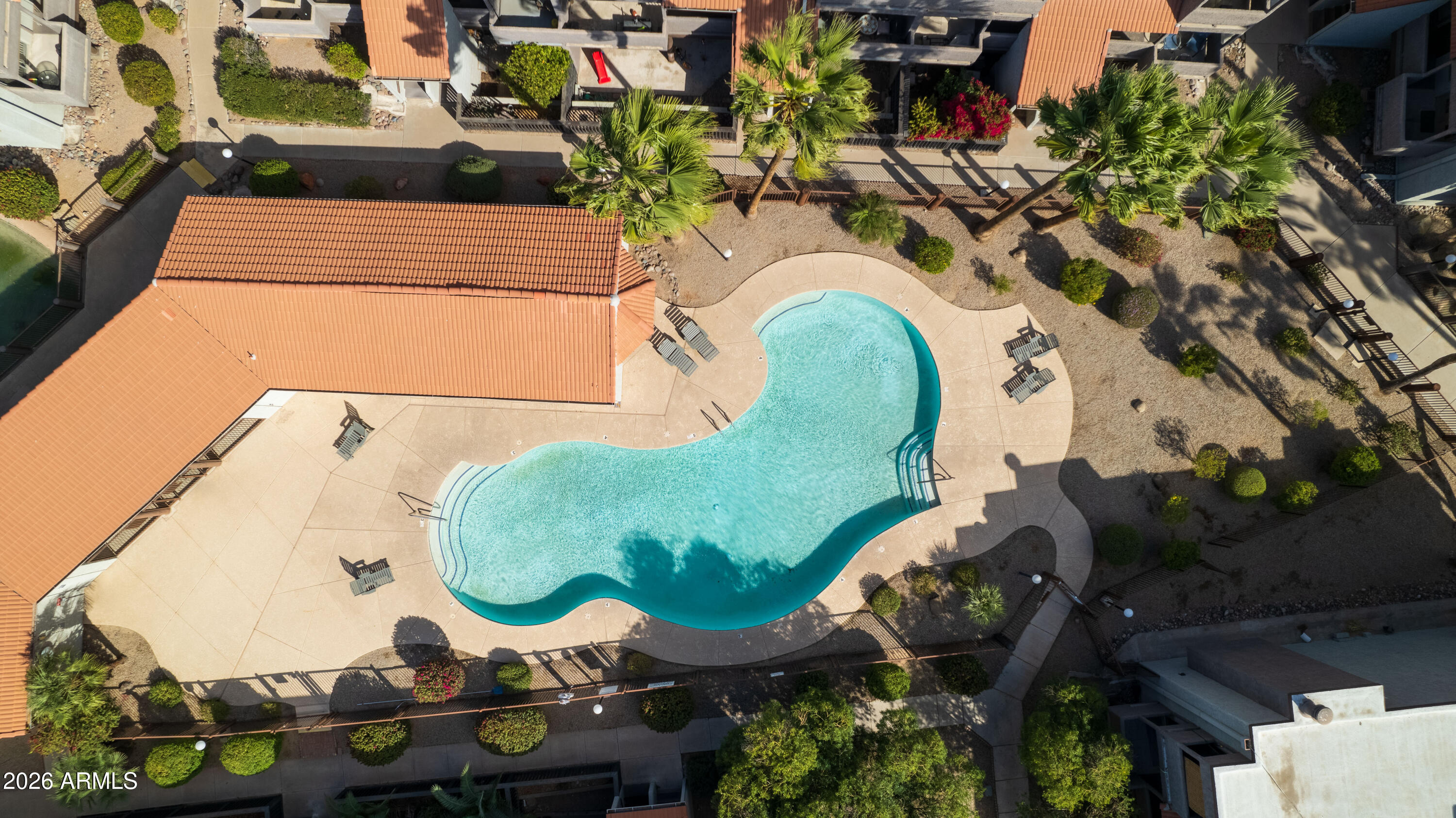 1645 West Baseline Road, Unit 2110 Mesa, AZ 85202 - Photo 16 of 17 an aerial view of a swimming pool with outdoor seating and plants