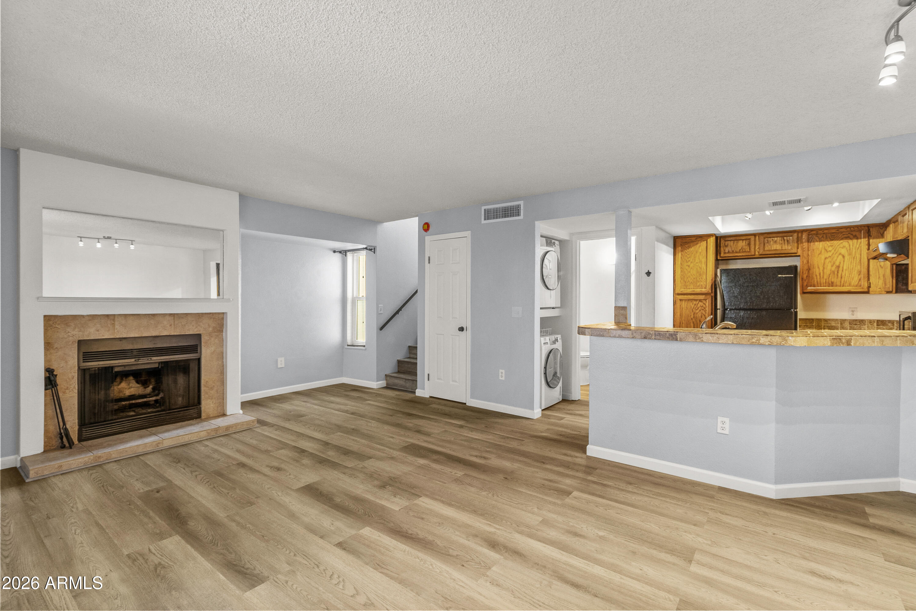 1645 West Baseline Road, Unit 2110 Mesa, AZ 85202 - Photo 2 of 17 a view of empty room with wooden floor and fireplace