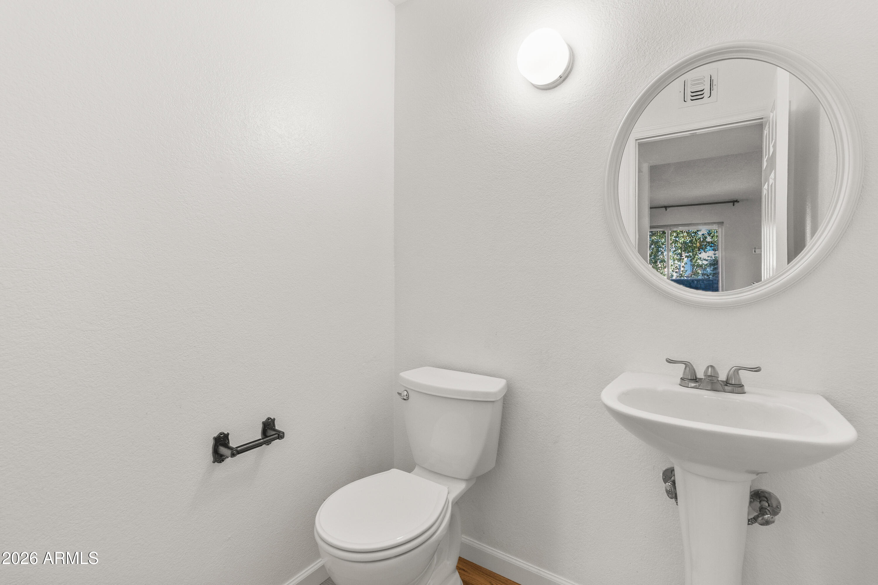 1645 West Baseline Road, Unit 2110 Mesa, AZ 85202 - Photo 7 of 17 a bathroom with a toilet sink and mirror