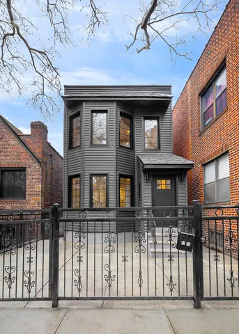 a front view of a residential apartment building with a street