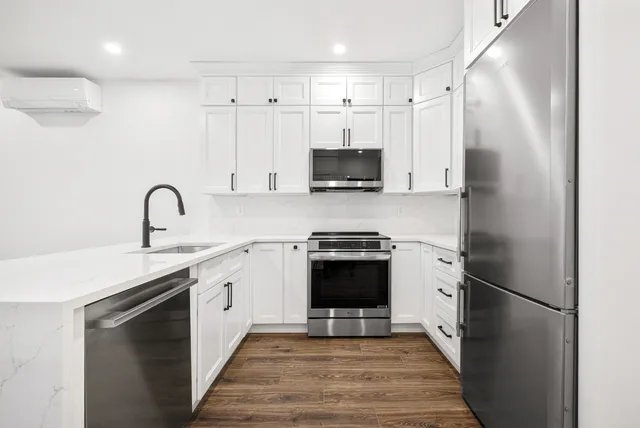 a kitchen with stainless steel appliances a refrigerator sink and microwave