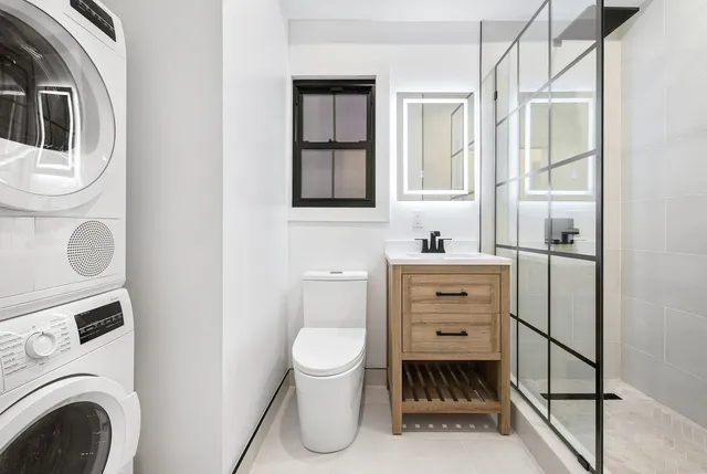 a bathroom with a toilet sink and a mirror