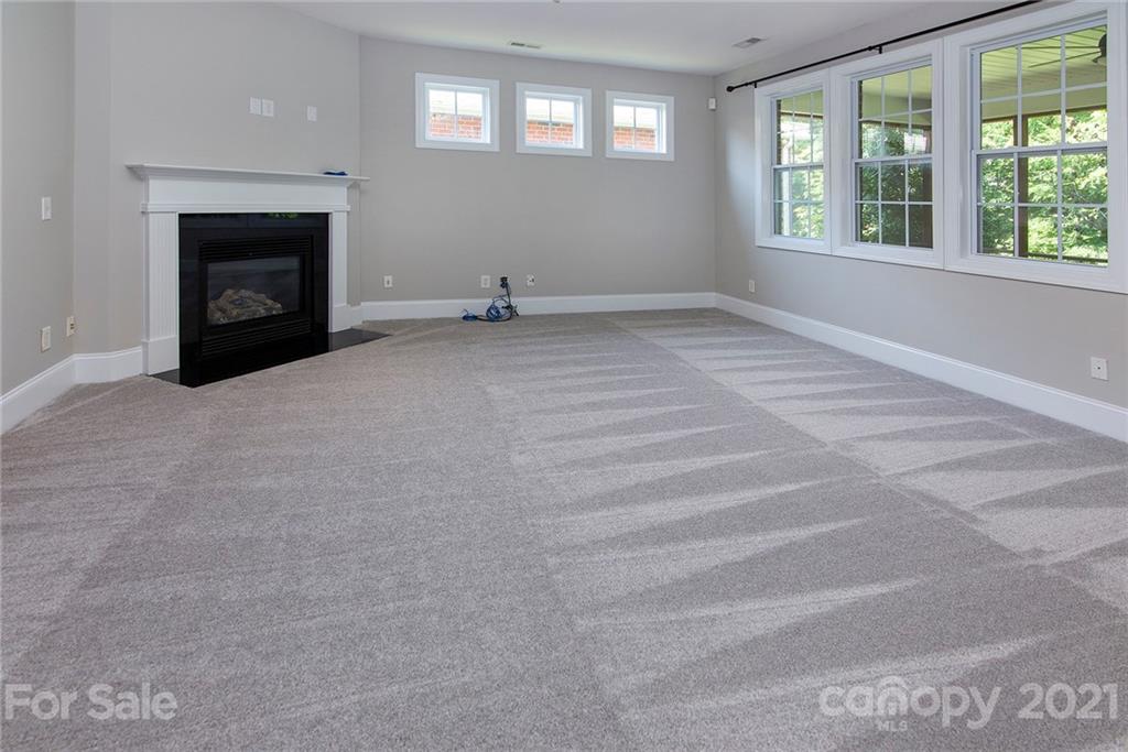 10617 Round Rock Road Charlotte, NC 28277 - Photo 2 of 28 an empty room with a fireplace and windows
