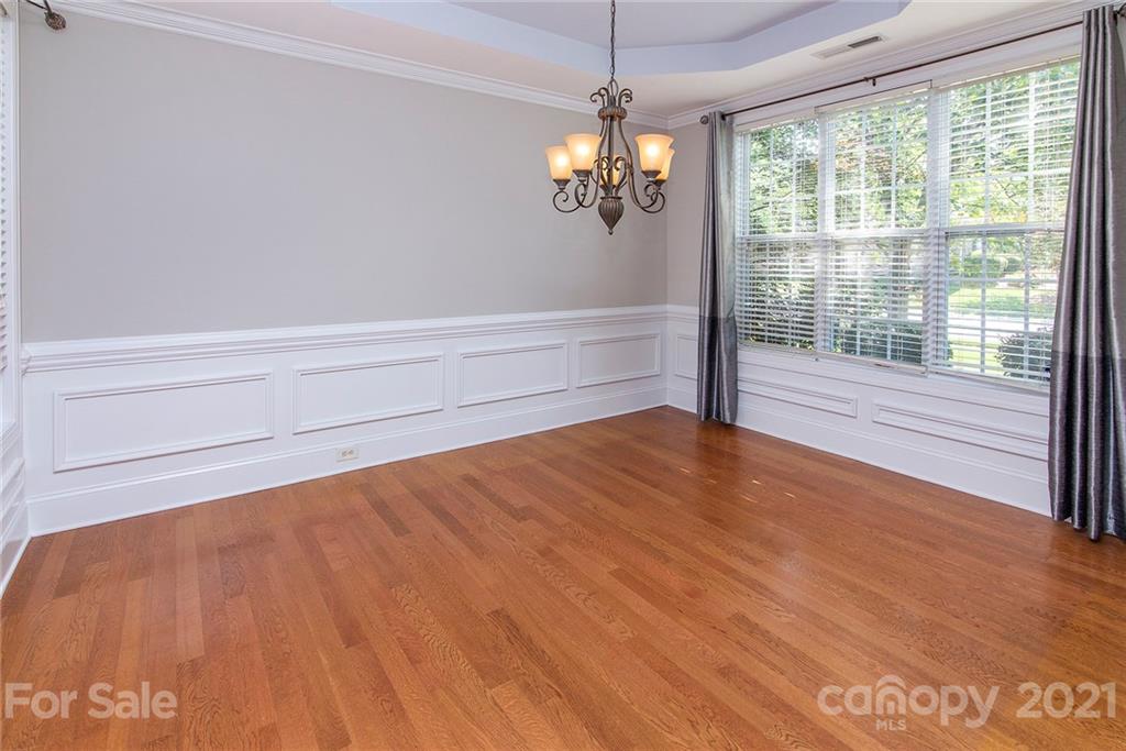 10617 Round Rock Road Charlotte, NC 28277 - Photo 11 of 28 a view of empty room with wooden floor and fan