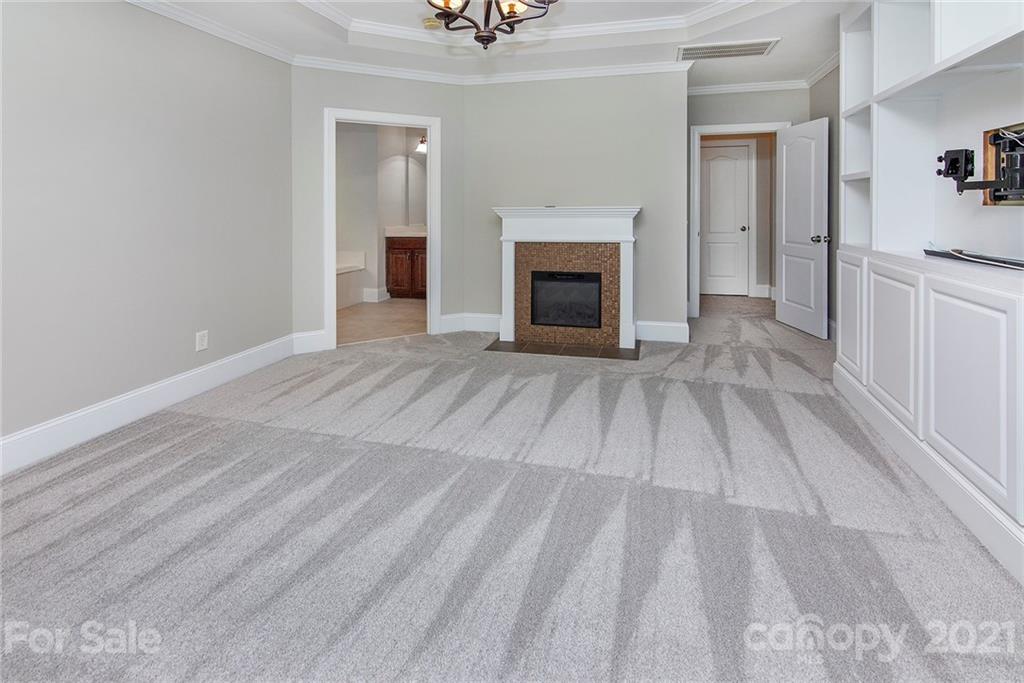 10617 Round Rock Road Charlotte, NC 28277 - Photo 13 of 28 a view of empty room with wooden floor and fireplace