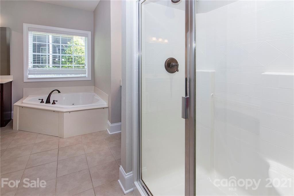 10617 Round Rock Road Charlotte, NC 28277 - Photo 16 of 28 a white bath tub sitting next to a sink