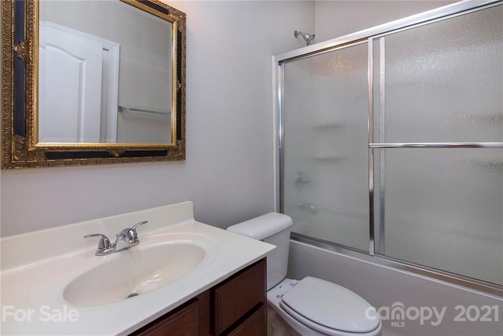 10617 Round Rock Road Charlotte, NC 28277 - Photo 22 of 28 a bathroom with a sink a mirror and a toilet