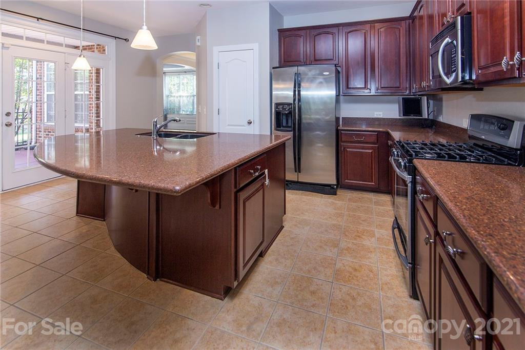 10617 Round Rock Road Charlotte, NC 28277 - Photo 4 of 28 a kitchen with stainless steel appliances granite countertop a sink a stove and a refrigerator