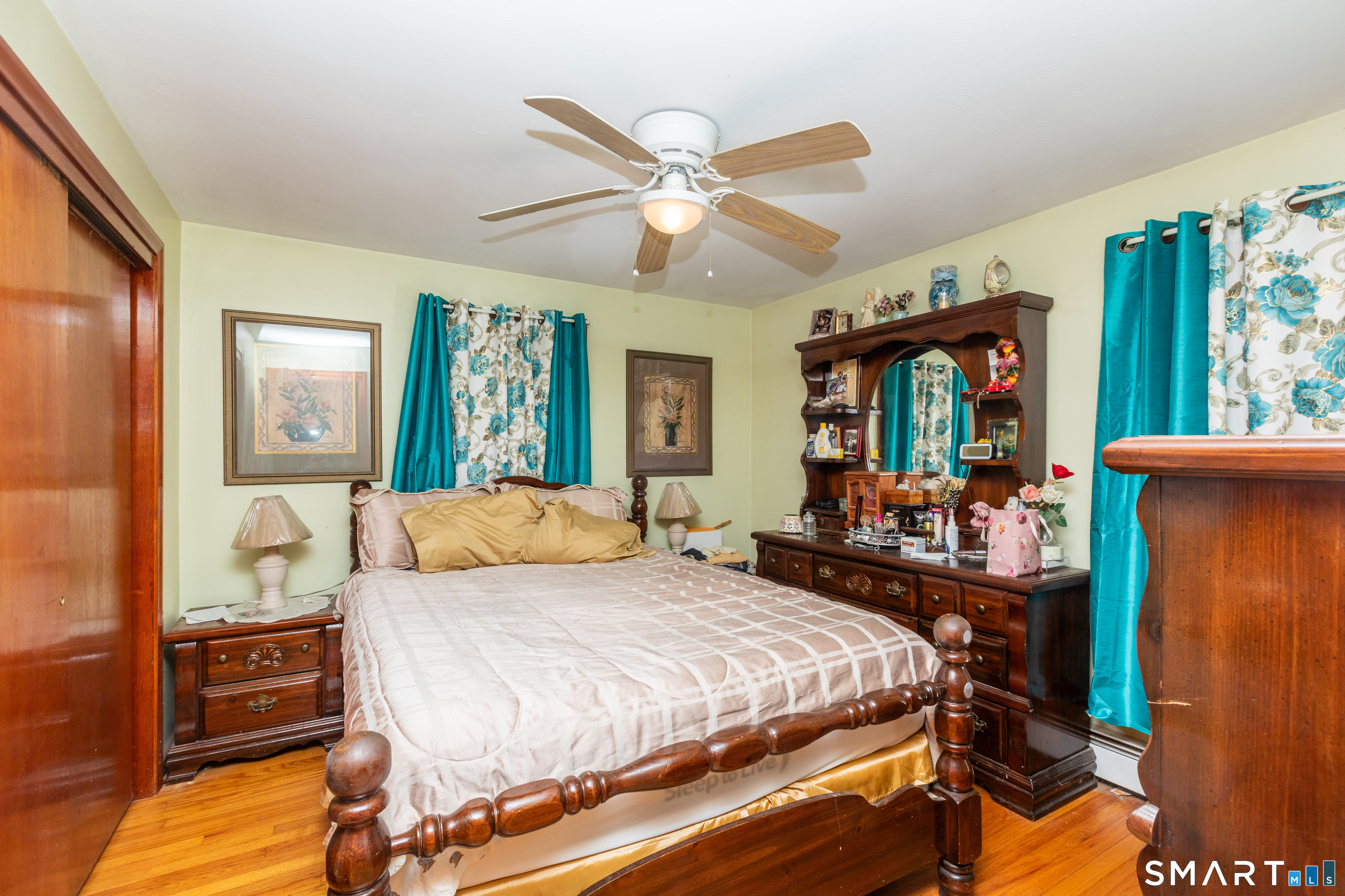 97 Benson Street New Britain, CT 06051 - Photo 14 of 24 a bedroom with a bed and wooden floor