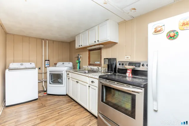 a kitchen with a stove top oven sink and cabinets