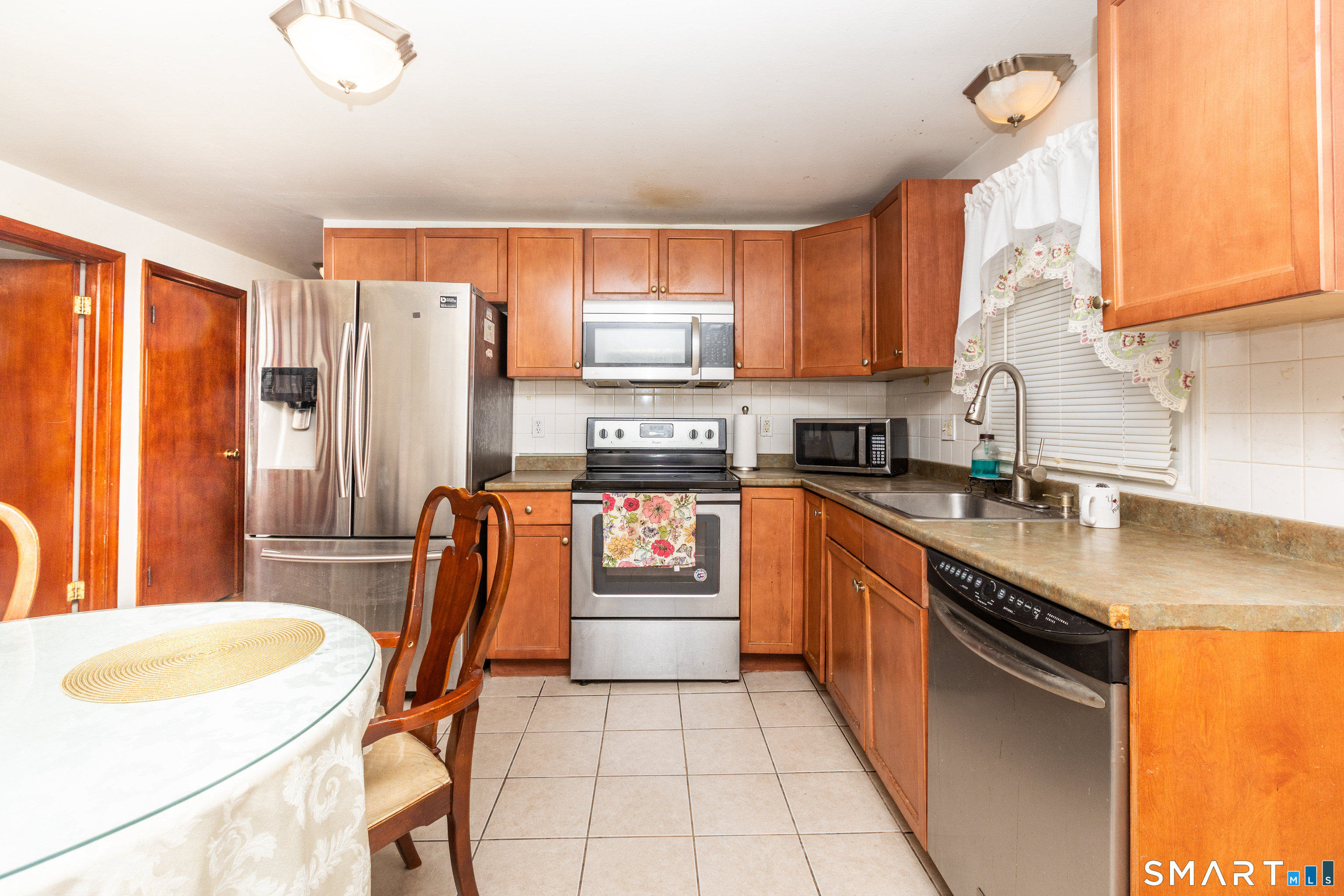 97 Benson Street New Britain, CT 06051 - Photo 3 of 24 a kitchen with granite countertop stainless steel appliances a sink and a refrigerator