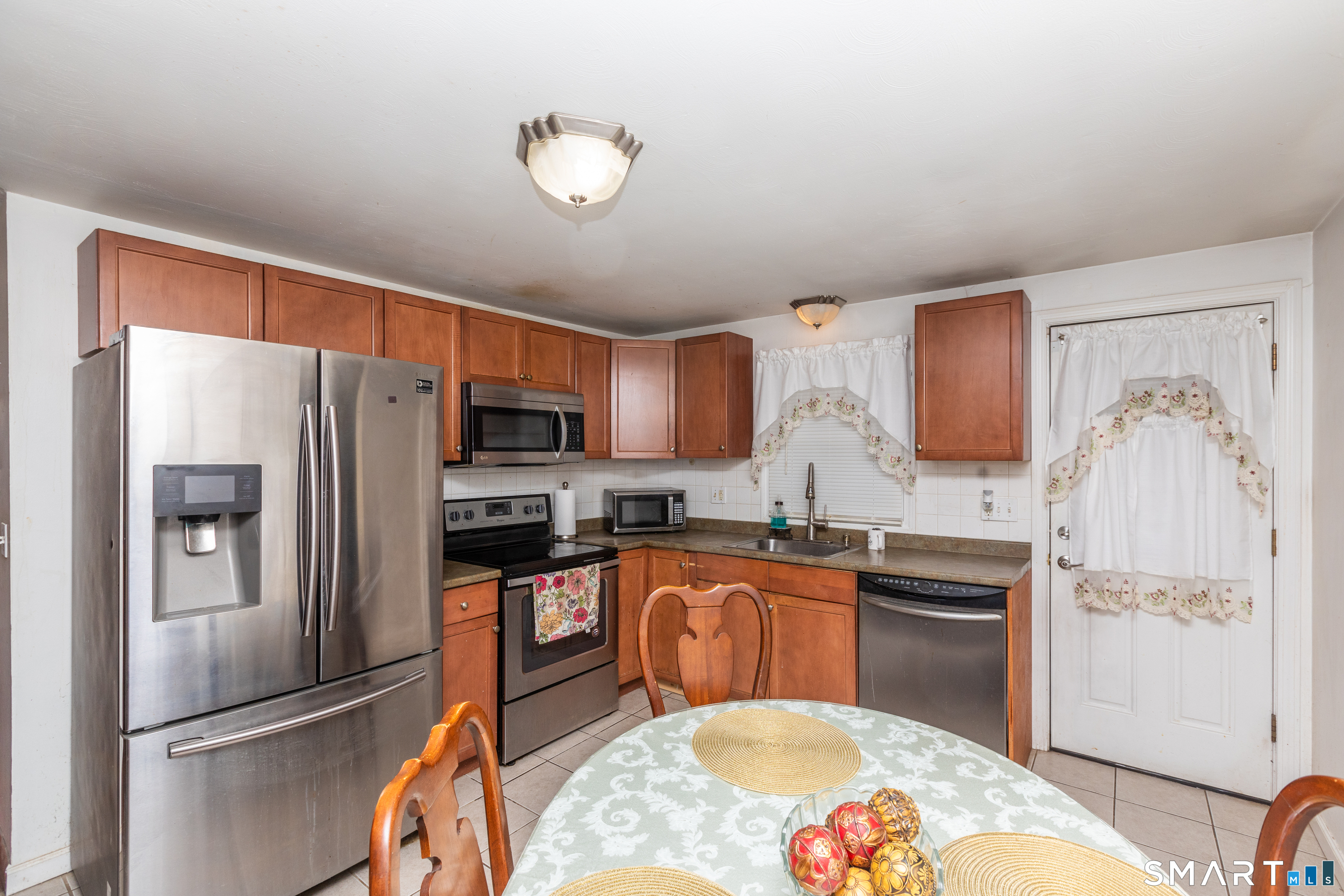 97 Benson Street New Britain, CT 06051 - Photo 8 of 24 a kitchen with stainless steel appliances granite countertop a refrigerator and a stove top oven