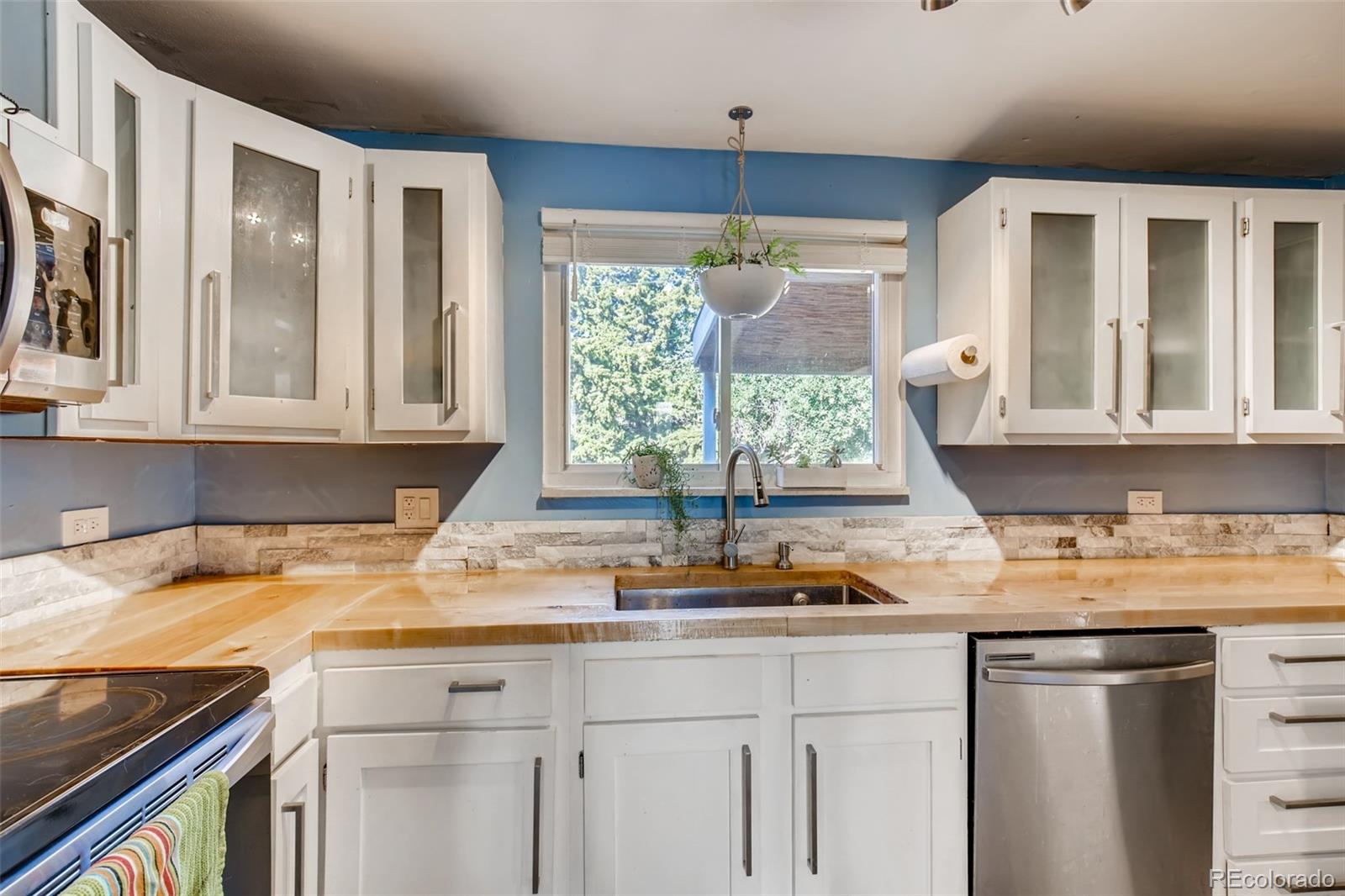 4611 Pierce Street Wheat Ridge, CO 80033 - Photo 12 of 30 a kitchen with a sink and a window