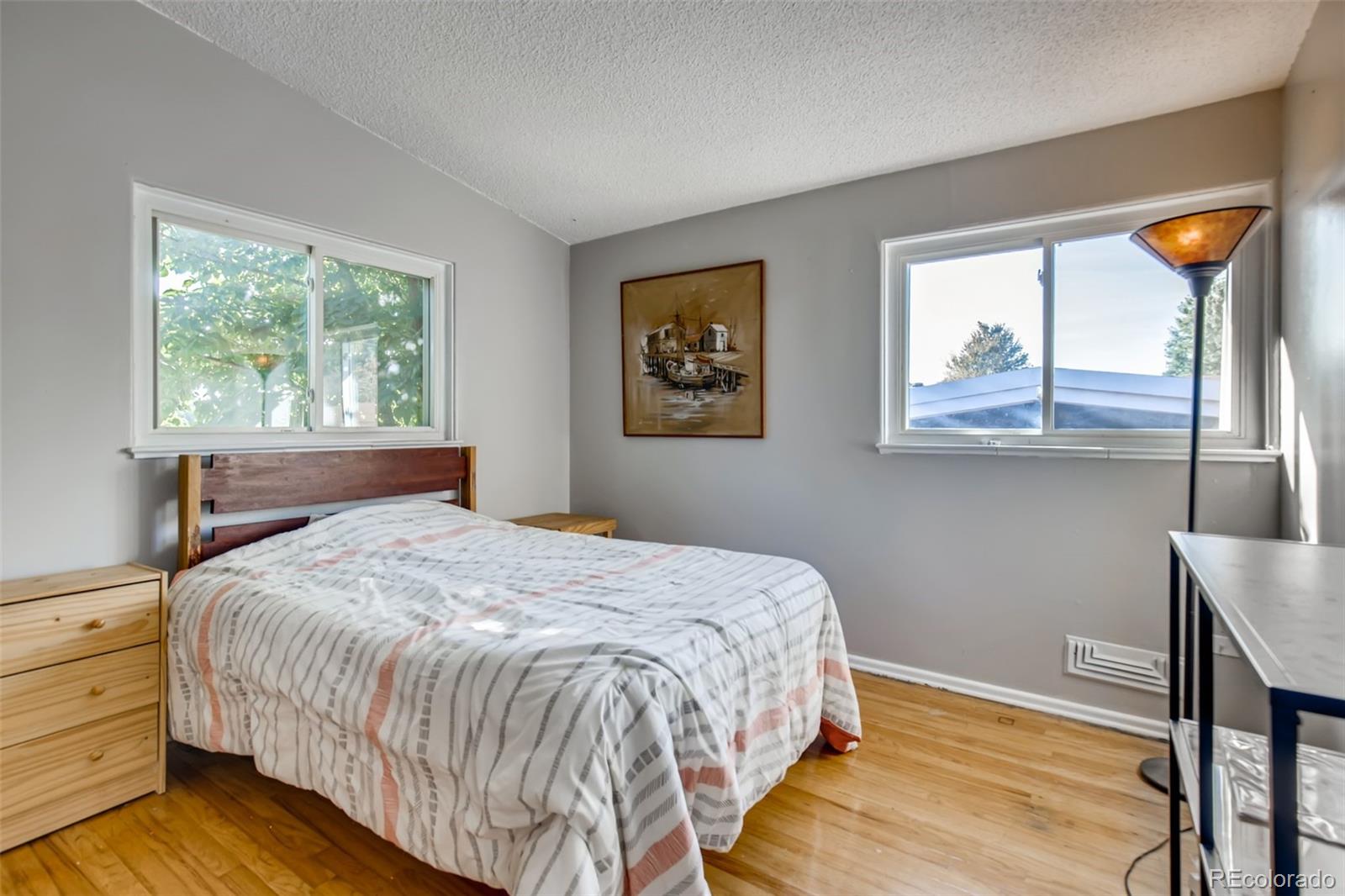 4611 Pierce Street Wheat Ridge, CO 80033 - Photo 19 of 30 a bedroom with a bed and a window