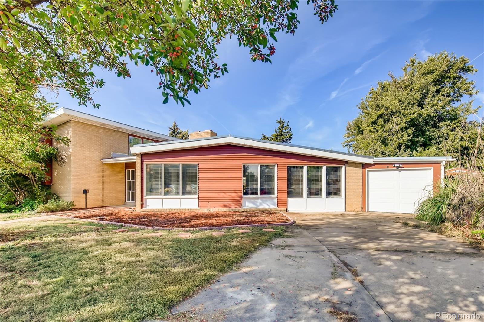 4611 Pierce Street Wheat Ridge, CO 80033 - Photo 3 of 30 a front view of a house with a garden