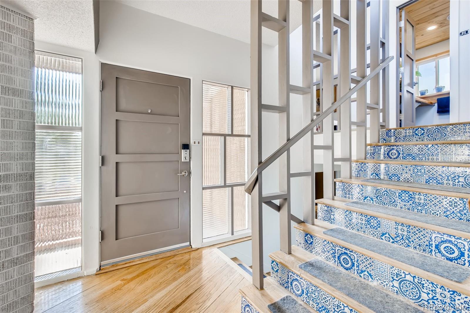 4611 Pierce Street Wheat Ridge, CO 80033 - Photo 4 of 30 a view of staircase with white walls and railing