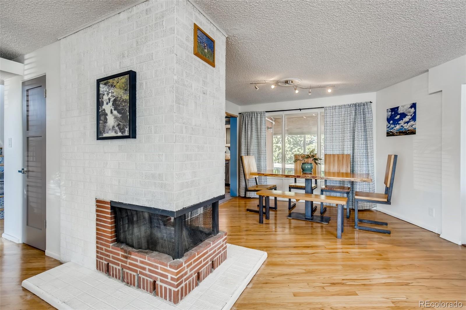4611 Pierce Street Wheat Ridge, CO 80033 - Photo 10 of 30 a living room with furniture and a fireplace
