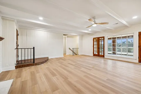 a kitchen with stainless steel appliances a sink a stove a refrigerator cabinets and a counter top space