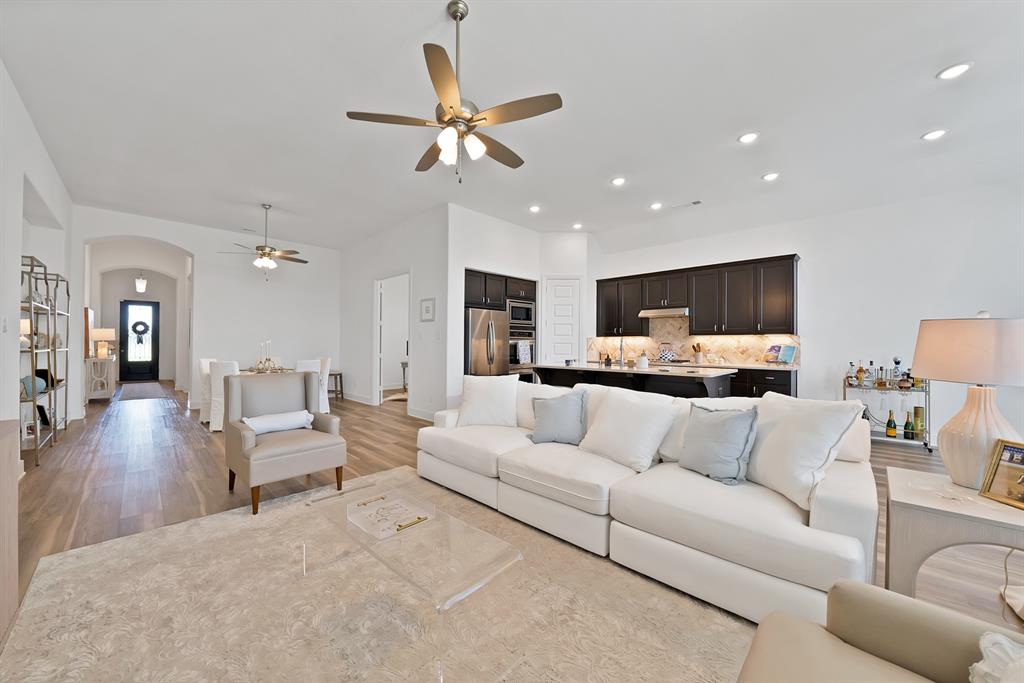 1709 Shetland Road Aubrey, TX 76227 - Photo 2 of 35 a living room with furniture and a wooden floor