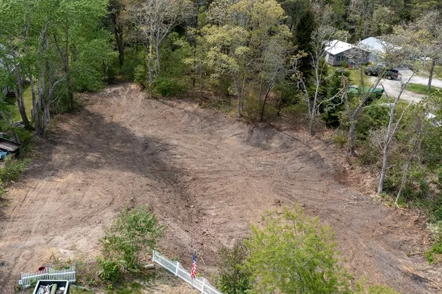 an aerial view of a house with a yard