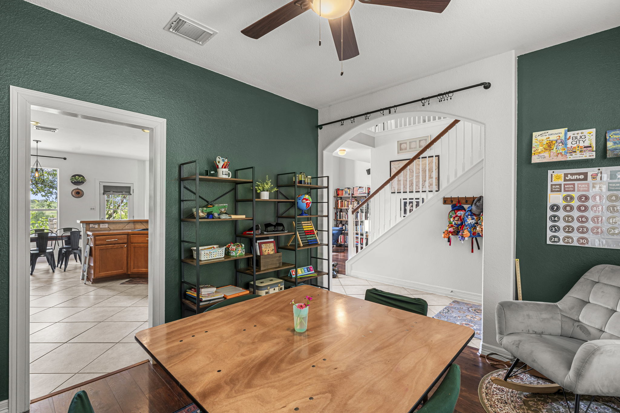 454 Fall Circle Kyle, TX 78640 - Photo 6 of 39 A versatile space features built-in shelving, hardwood flooring, and an adjoining kitchen.