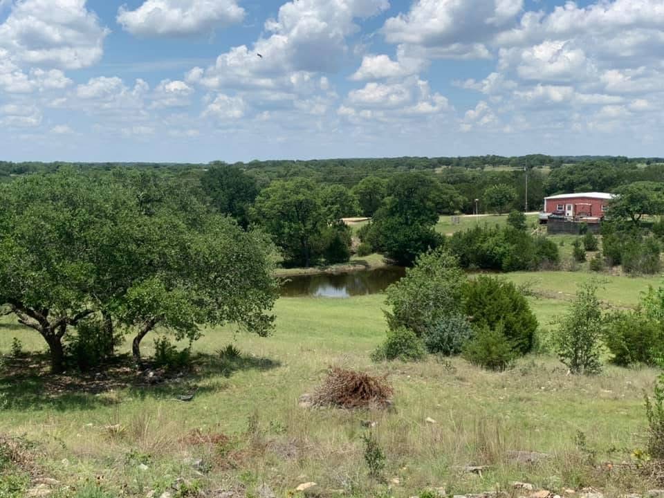 6350 Mt Sharp Road, Unit B Wimberley, TX 78676 - Photo 28 of 36 Green pastures and a calm wet weather pond