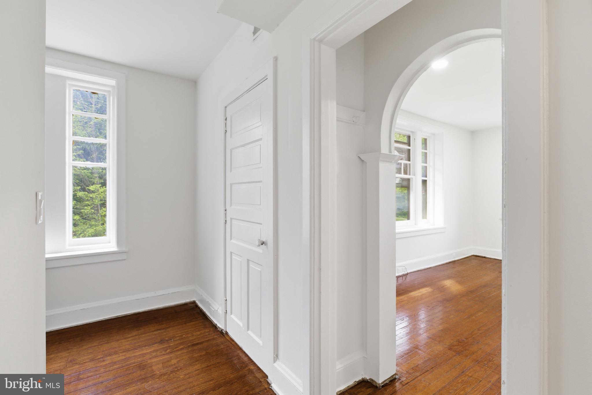 5939 Drexel Road, Unit 2 Philadelphia, PA 19131 - Photo 1 of 17 a view of an empty room with wooden floor and a window