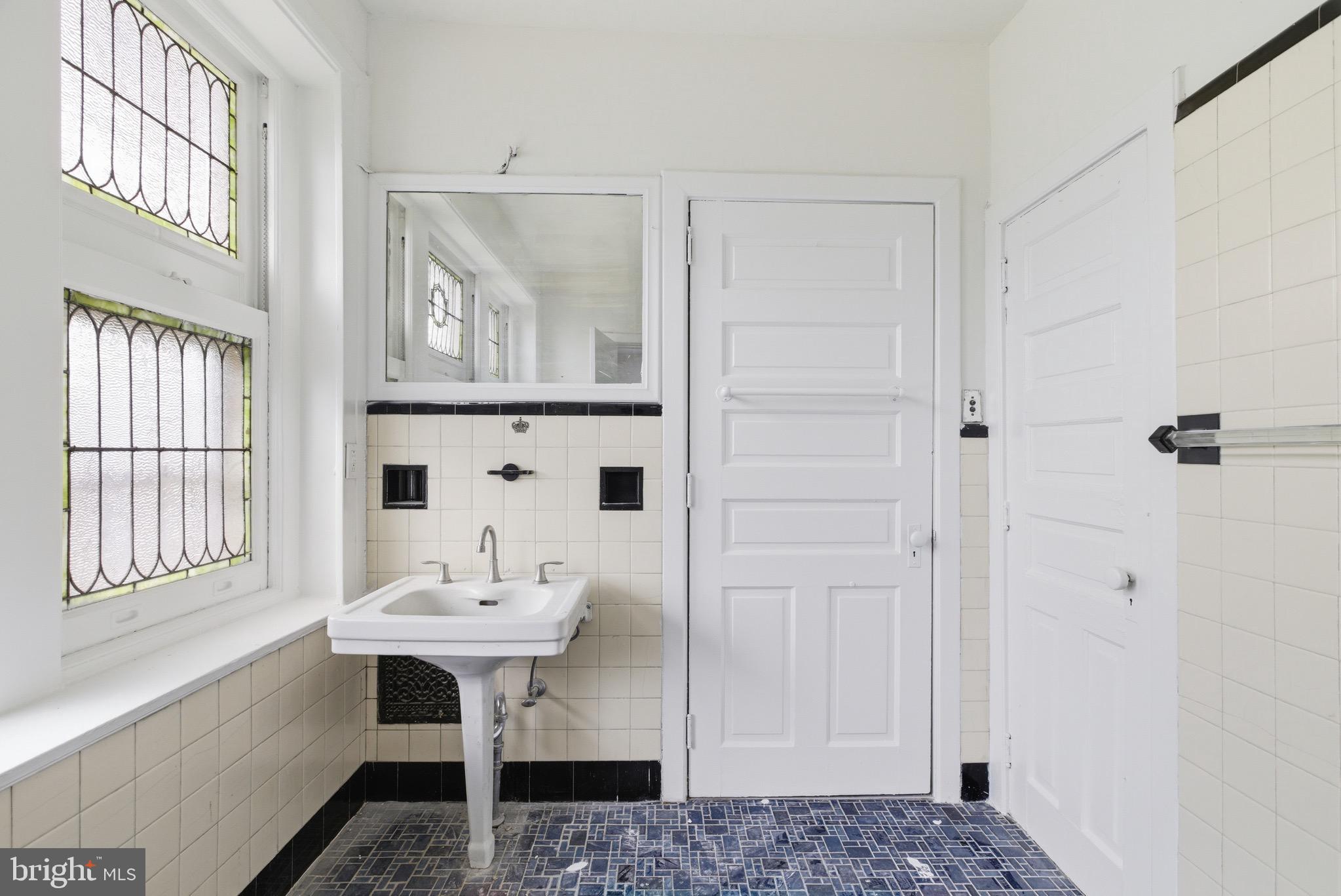 5939 Drexel Road, Unit 2 Philadelphia, PA 19131 - Photo 11 of 17 a bathroom with a sink a mirror and a shower