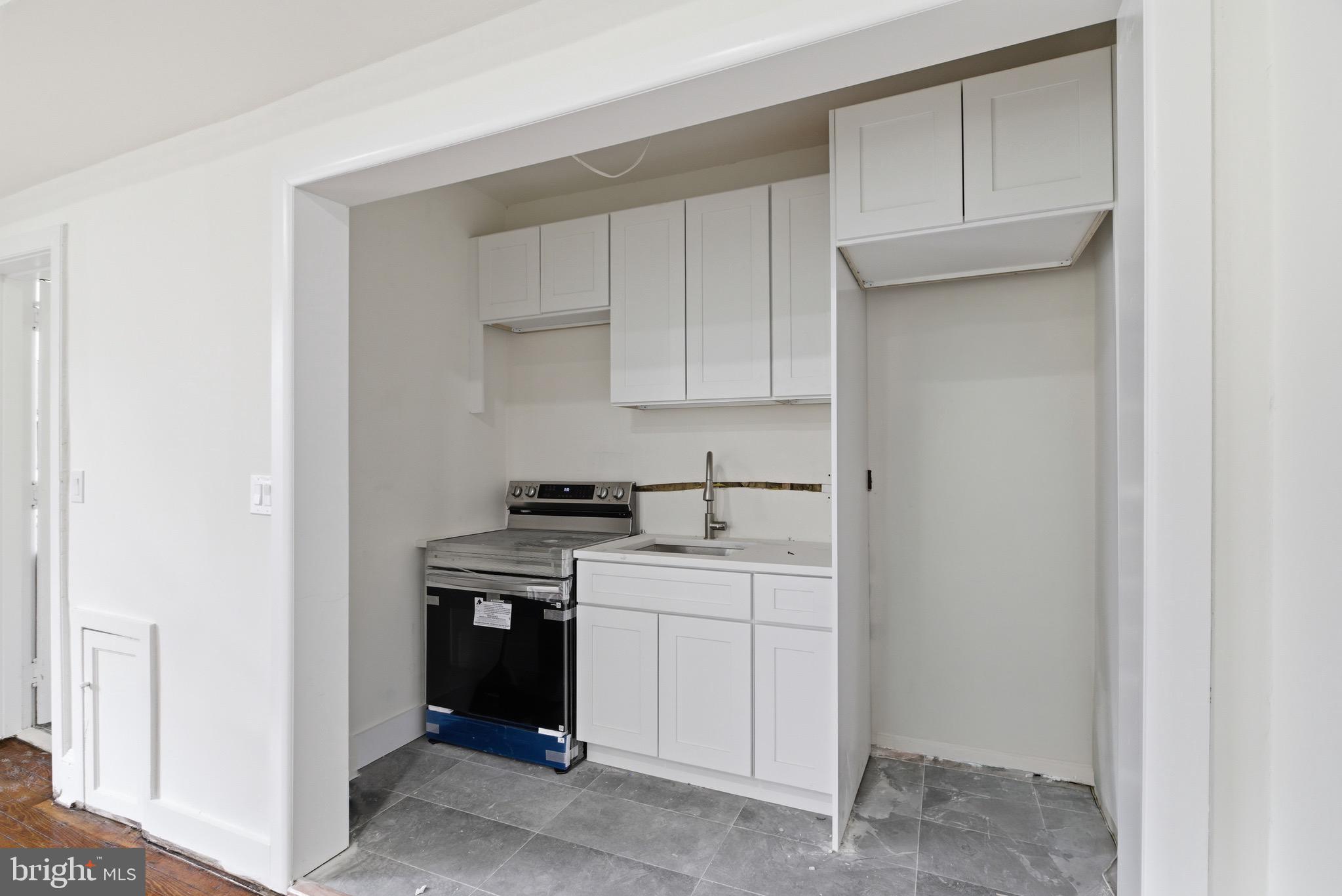 5939 Drexel Road, Unit 2 Philadelphia, PA 19131 - Photo 13 of 17 a kitchen with a sink and a stove